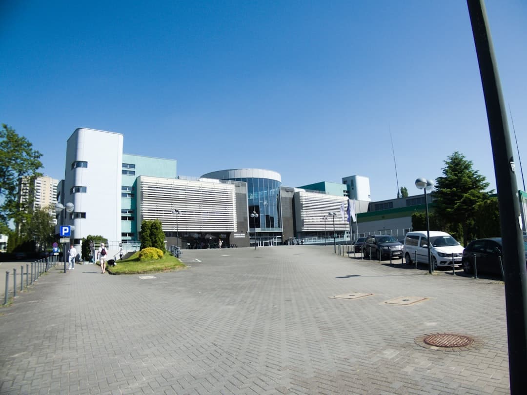Large modern building with a wide paved forecourt.